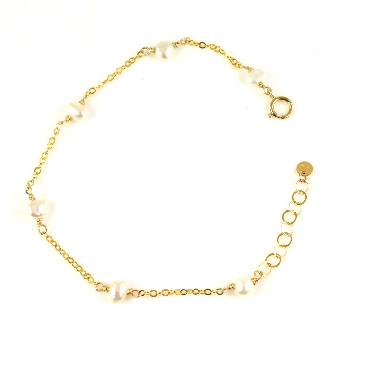 Gold bracelet with pearls on a white background