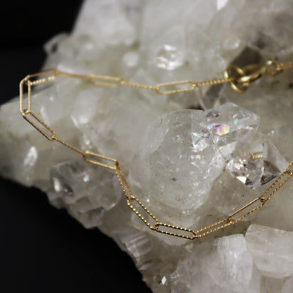 Gold chain necklace on a crystal background