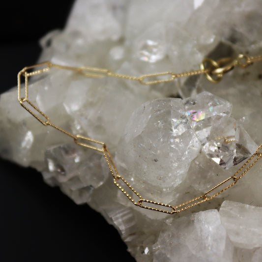 Gold chain necklace on a crystal background