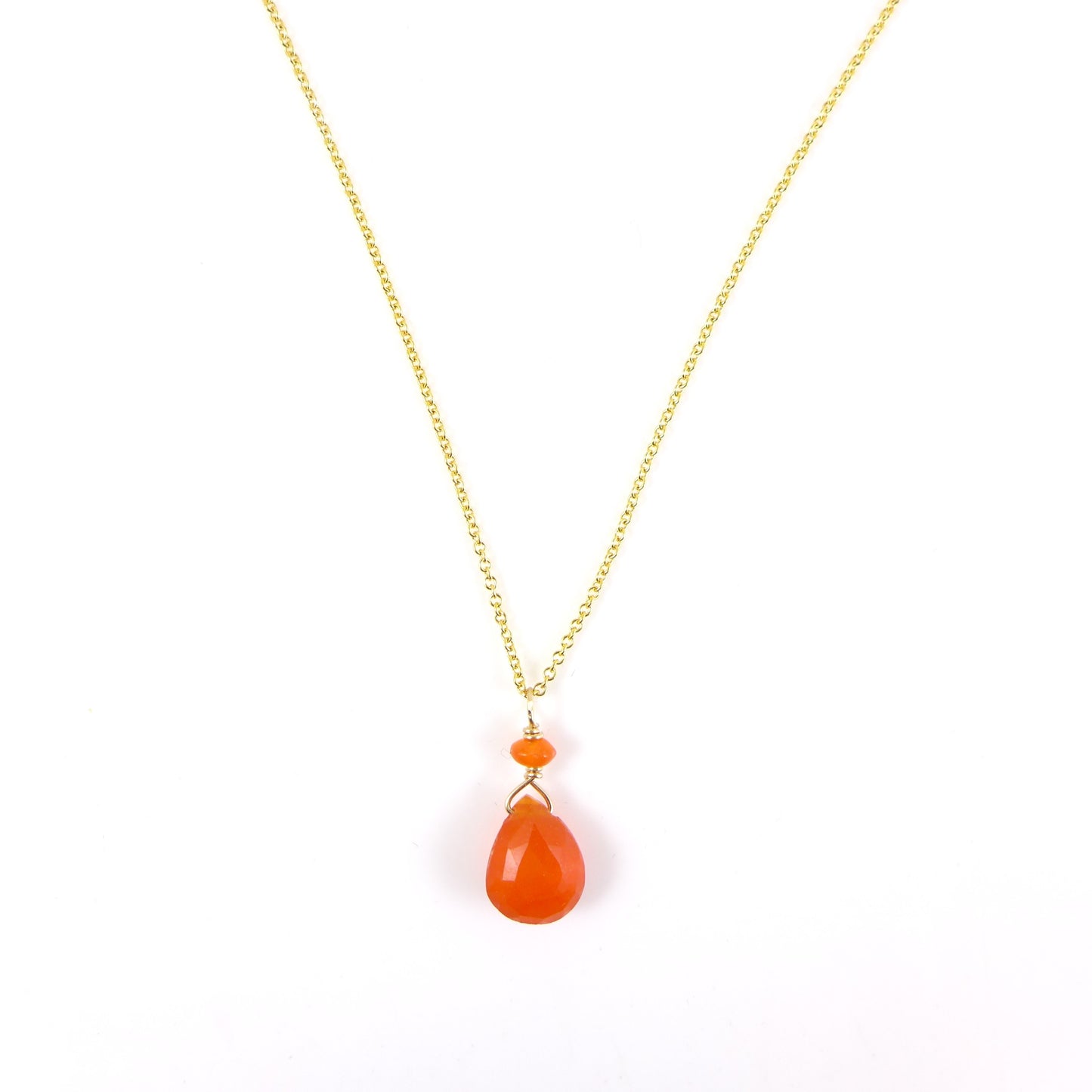 A gold chain necklace featuring a teardrop-shaped orange carnelian pendant