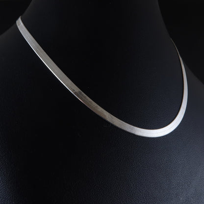 Silver flat chain  necklace on a black mannequin