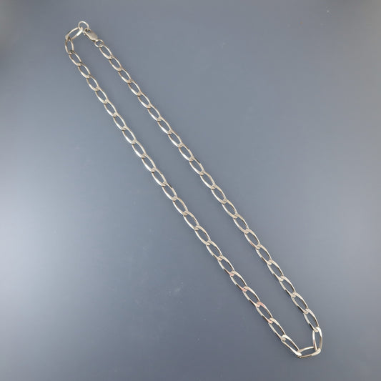 Silver chain necklace on a gray background