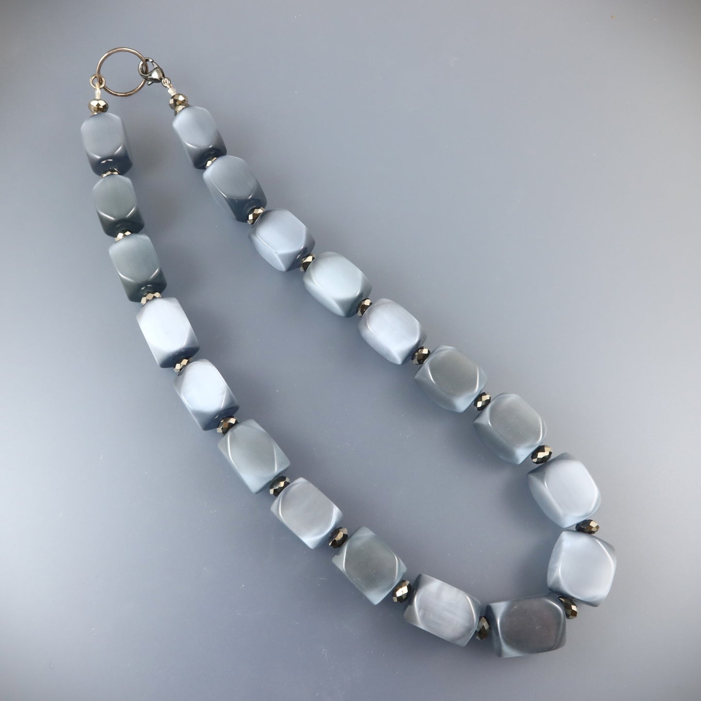 Necklace with hexagonal beads on a gray background