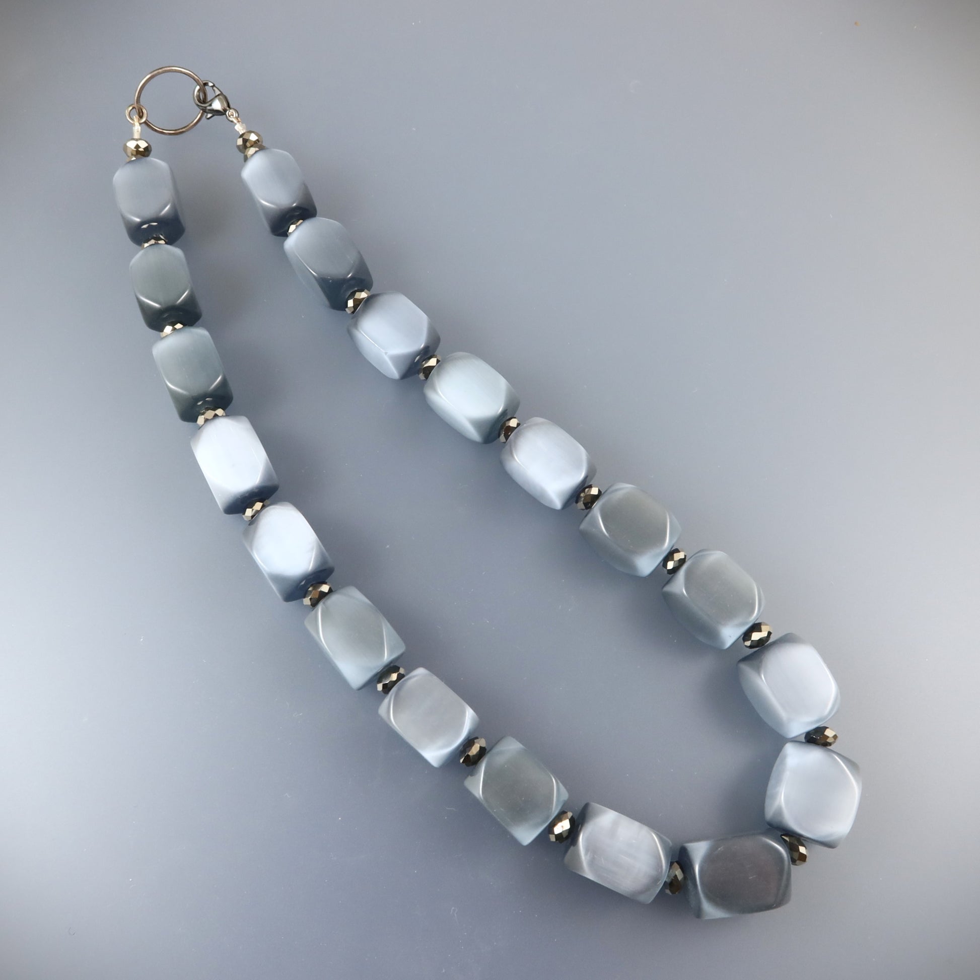 Necklace with hexagonal beads on a gray background