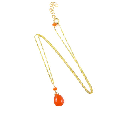 A gold chain necklace featuring a teardrop-shaped orange carnelian pendant